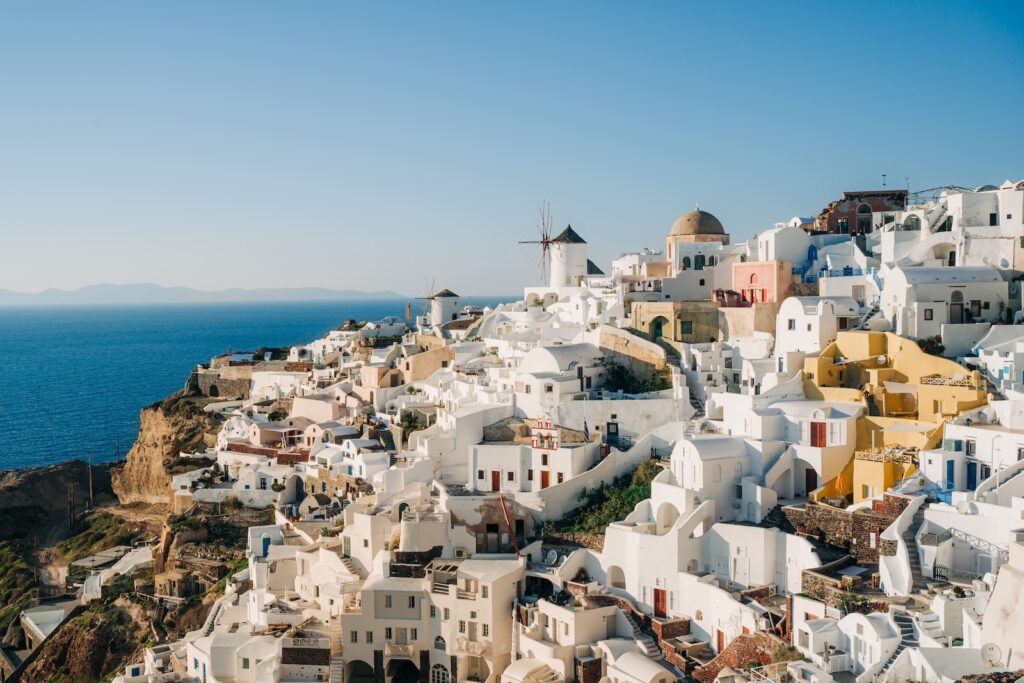 a view of a village on a cliff overlooking the ocean